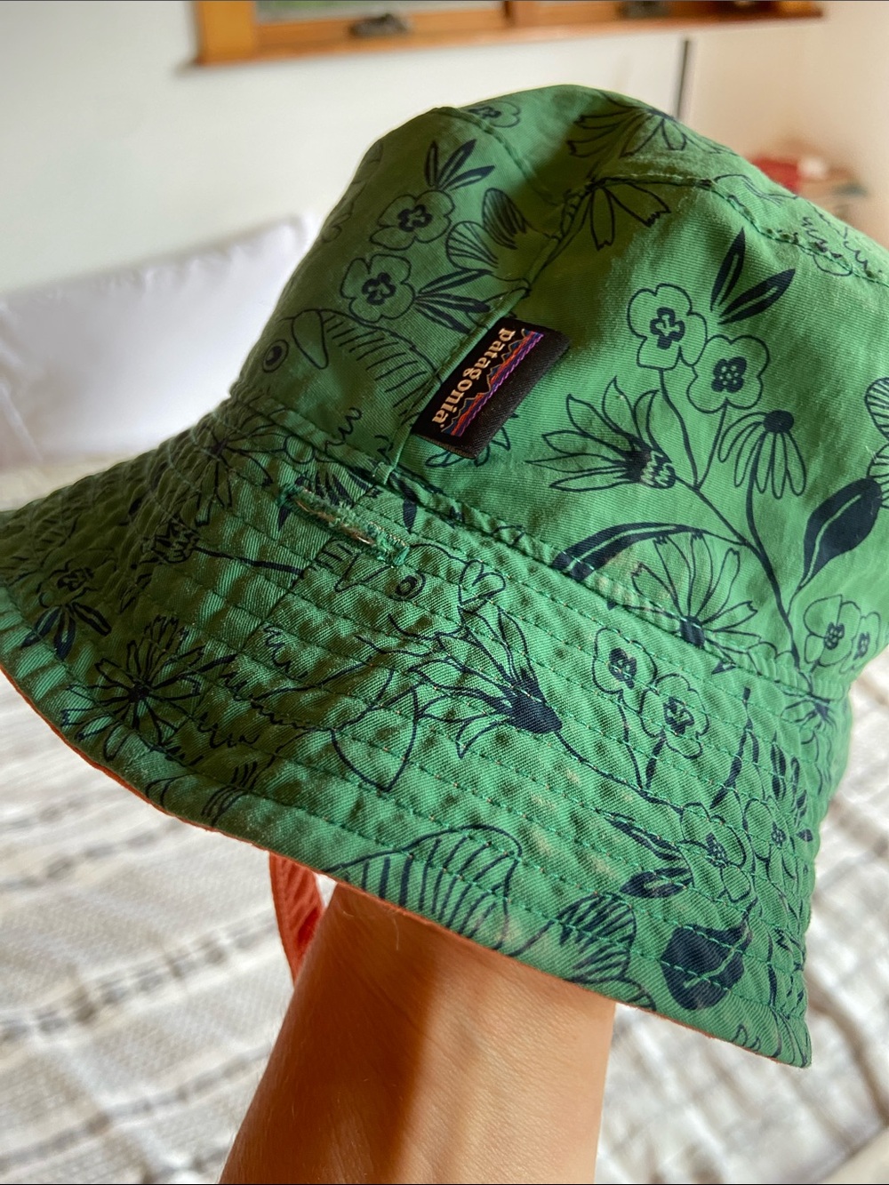 Patagonia Green Kids Sun Bucket Hat with Navy Fish and Floral Print.